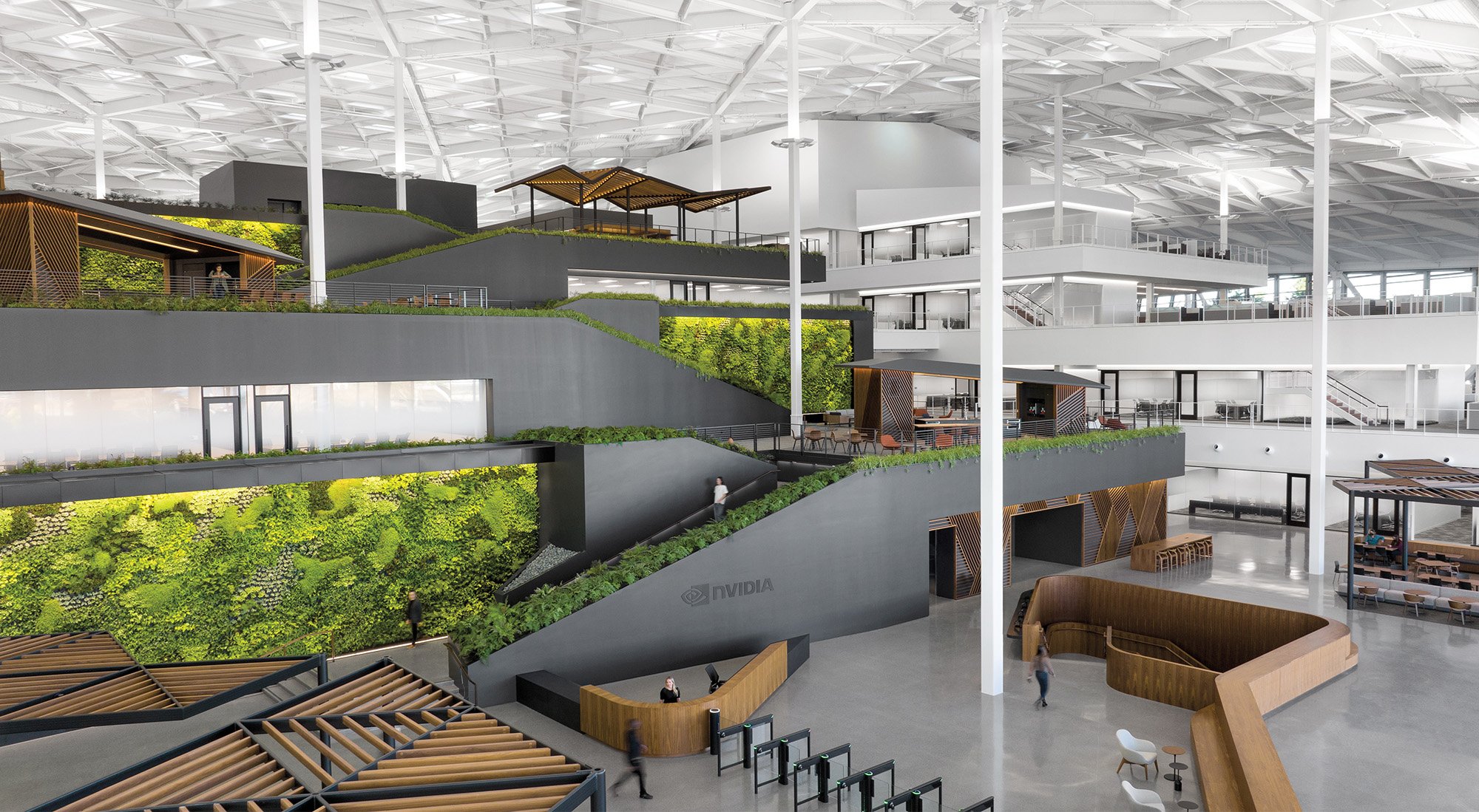 Interior renders of the NVIDIA campus with large double height strcutures filled with garden walls and open layouts held together and covered with thin white beams that hold the massive steel roof structure. 