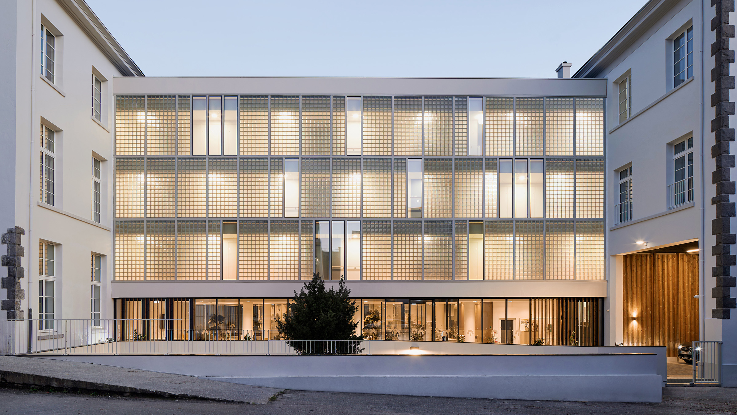 Front facade covered in performance glass of a senior living residence building.