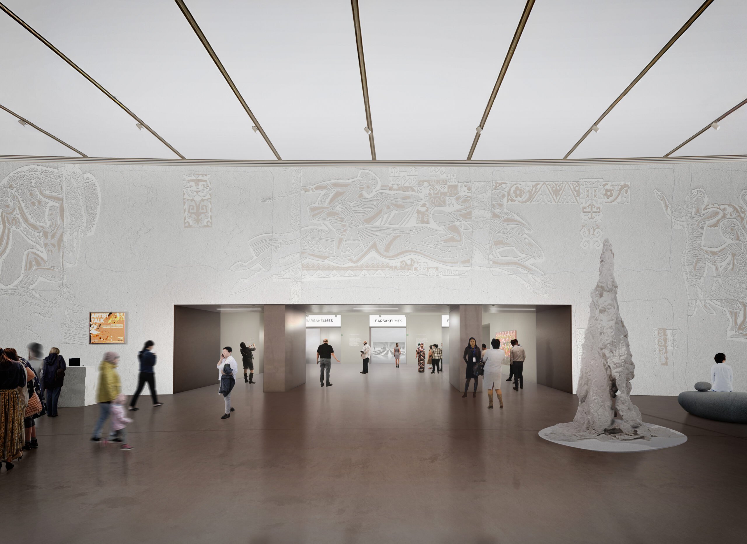 Inside an all white bright lit museum floor with a sculpture and lots of people viewing the art. The walls are carved with intricate art.
